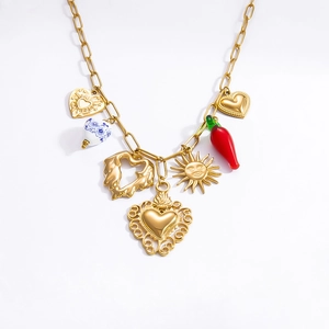 Detailed shot of gold link chain necklace with various heart, sun, and chili charms