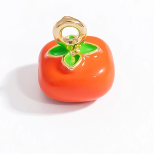 Gros plan détaillé d'un pendentif kaki orange brillant avec anneau doré sur fond blanc