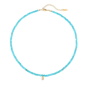 Dettaglio collana con perle turchesi e ciondolo lettera B in cristallo con chiusura oro