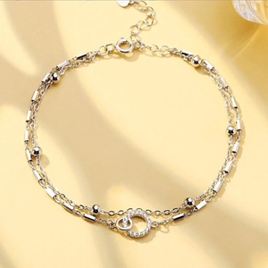 Silberne doppellagige Rosen-Dornen-Armband mit verschlungenen Ringen und Zirkonia-Details