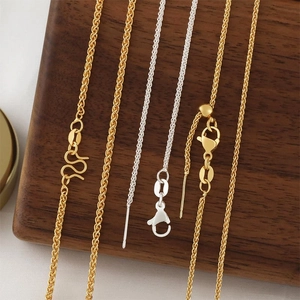 18k gold and silver adjustable Chopin chain necklaces with pins on wooden display