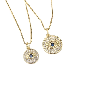 Golden Evil Eye pendant necklace with sparkling white zircons and a deep blue center stone
