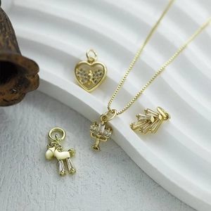Close-up of golden pendant set with micro-inlaid zircons and intricate vintage detailing