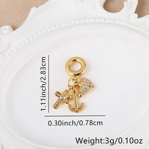 Detailed macro shot of 18k gold plated anchor cross heart charm with zircon inlay