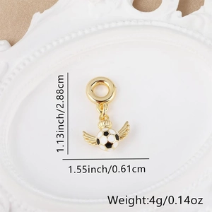 Macro detail of 18k gold plated soccer charm with wings and precise dimensions