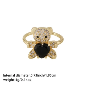 Gold bear ring with sparkling zircons holding a black heart gemstone on white background