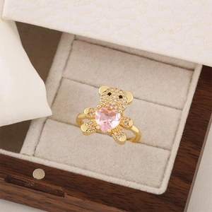 Gold teddy bear ring with sparkling zircons and pink heart stone in a premium jewelry box