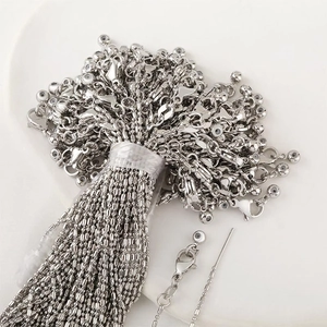 Silver bead chain necklaces with lobster clasp in bulk on a white ceramic plate