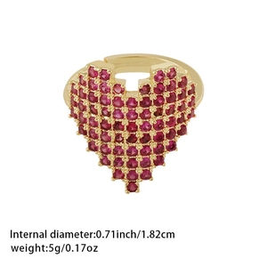 Detail view of large red heart-shaped ring with pavé stones and adjustable golden band