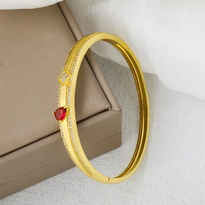 Elegant gold bracelet with heart-shaped red gemstone and fine micro-pave zircon detail