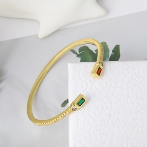 Minimalist gold brass open bangle with rectangular red and green zircon gemstones