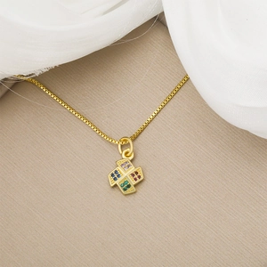 Elegant gold heart pendant necklace with colorful gems and windmill design on a silk background