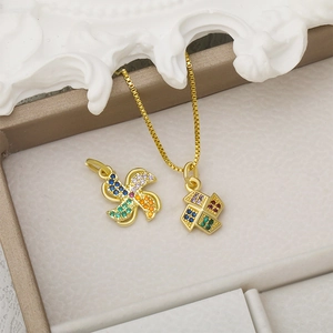 Golden windmill and heart geometric pendants with colorful zircons on creamy display box