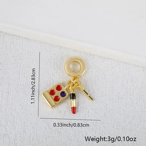 Macro shot of makeup palette and lipstick jewelry charm with dimensions and 3g weight