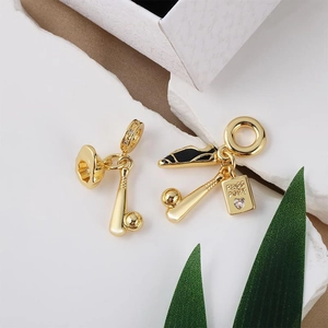 Golden baseball and passport charms set with crystal accents for charm bracelets