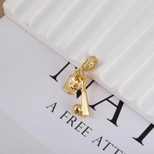 Golden baseball charm set with cap, bat, and ball featuring a sparkling rhinestone bail