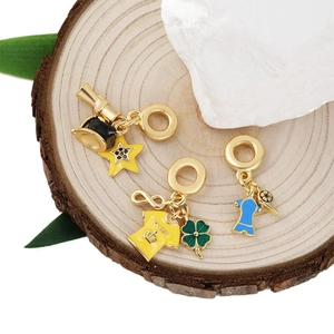 Golden sports charms featuring soccer jerseys and colorful enamel pendants for bracelets