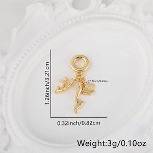 Macro detail of gold plated charms featuring coral, mermaid tail, and scallop shell motifs