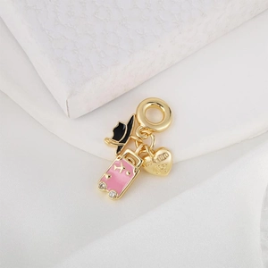 Gold-plated heart necklace pendant with pink enamel suitcase and sun hat charms