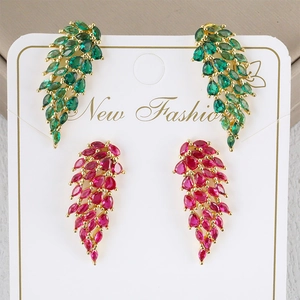 Colorful zircon angel wing stud earrings in green and magenta on display card