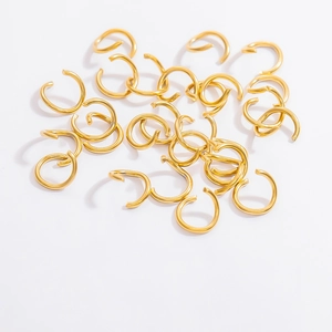 Macro shot of bright 18K gold-plated stainless steel jump rings for DIY jewelry making