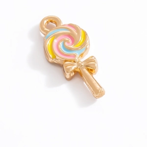 Detailed macro view of gold-plated lollipop charm with colorful enamel and golden bow