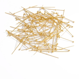 Macro shot of 18K gold plated ball head pins for jewelry making and DIY craft projects