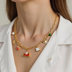 Detail of Christmas themed 18K gold plated necklace with reindeer and Santa charms