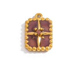 Close-up of 18K gold plated rectangular pendant with red enamel and star crystal