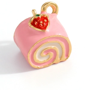 Macro detail of strawberry swiss roll pendant with pink enamel and gold plating