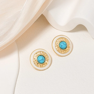 Vintage gold sunburst earrings with teal marble stone and silk background