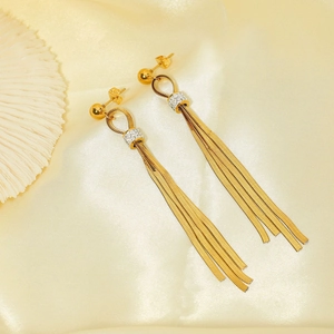 Golden tassel earrings set with rhinestones and snake chain fringe on coral display