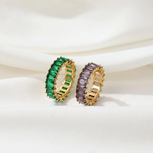Elegant gold rings set with rectangular green zircon and lilac purple gemstones