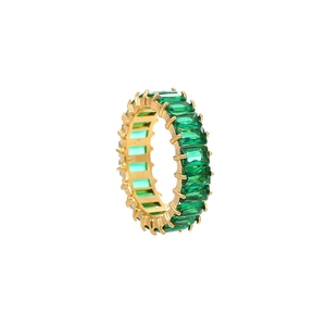 Close-up of gold eternity ring with emerald-cut green zirconia stones in claw setting