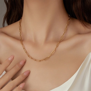 Élégant collier à maillons trombone plaqué or 18k porté par un mannequin pour un look chic