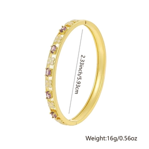 Detail view of gold-plated brass bangle with purple zircon and enamel floral patterns
