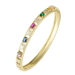 Golden bangle with colorful oval gemstones and white enamel floral elements on white background