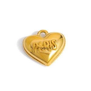 Macro view of golden heart pendant with embossed PARIS text and polished finish