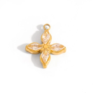 Macro detail of 14k gold-plated four-leaf flower pendant with marquise-cut crystals