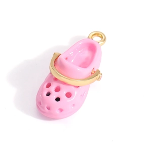 Detailed view of a pink enamel clog shoe pendant with gold metal handle and ring