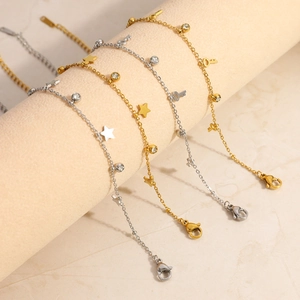 Detailed view of stainless steel bracelets with star, key, and zircon pendants