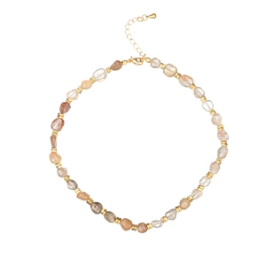 Macro detail of natural stone beaded necklace with gold spacers and lobster clasp
