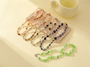 Macro detail of natural stone beaded bracelets in assorted colors with metal accents