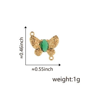 Macro view of 18k gold butterfly pendant with green gemstone and size measurements