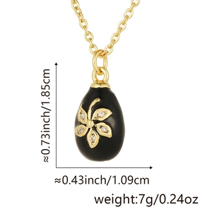Macro detail of enamel egg pendant with dimensions 1.85x1.09cm and gold flower pattern