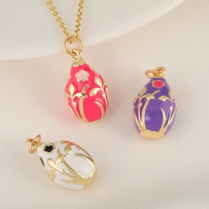 Oval 18K gold plated pendant with enamel floral patterns on elegant silk fabric