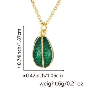Detailed view of green enamel egg pendant with gold lattice texture and dimensions