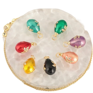 Set of seven colorful enamel egg pendants with gold accents and sparkling crystals