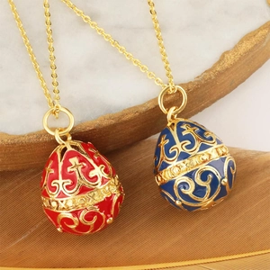 Exquisite hollow egg pendant necklace with intricate gold patterns in red and blue