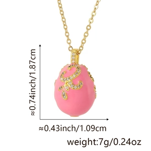 Detailed dimensions of pink enamel egg pendant with gold scrollwork and white zircons